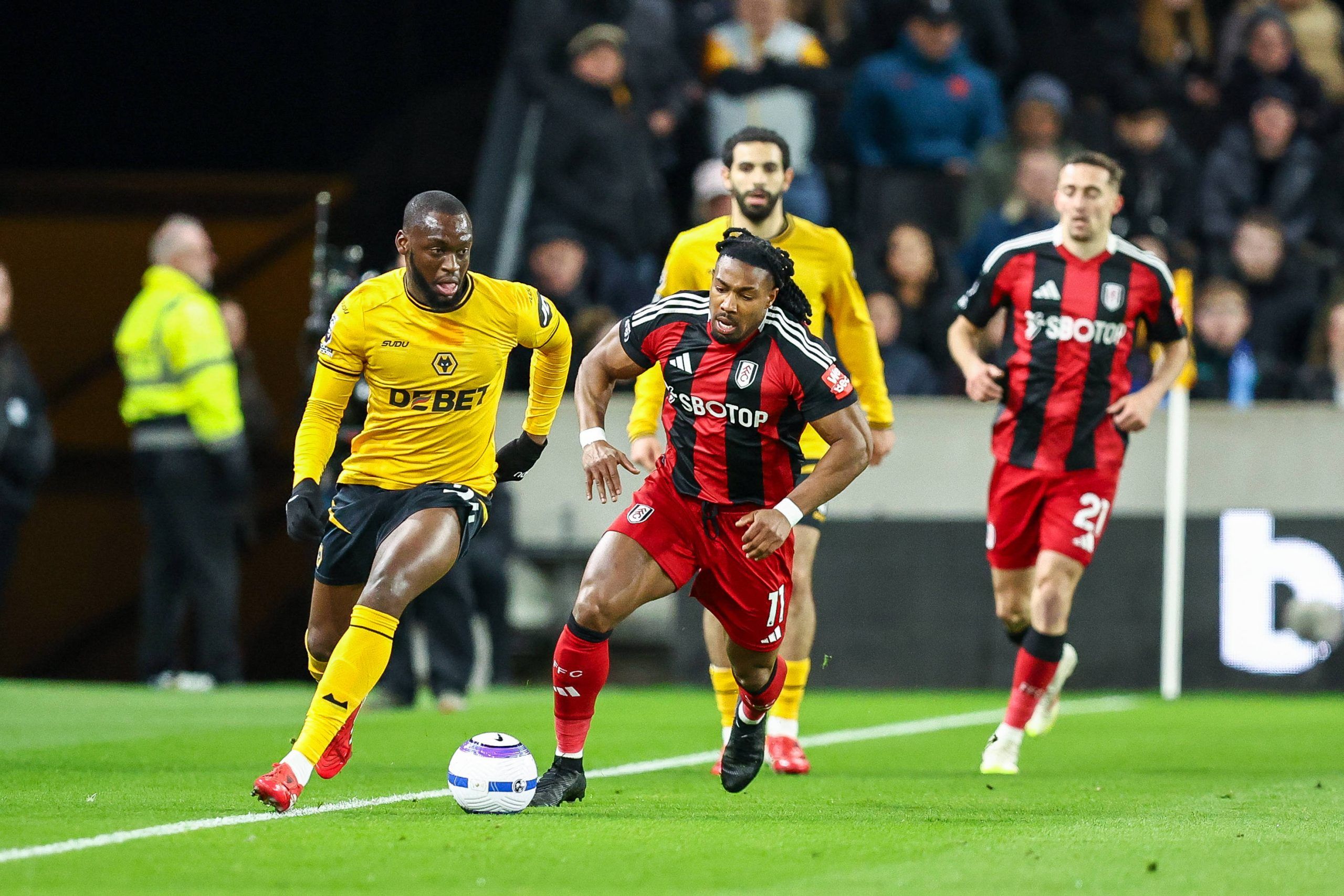 Toti Gomes and Adama Traore battle for possession during the Premier League match between Wolverhampton Wanderers and Fulham