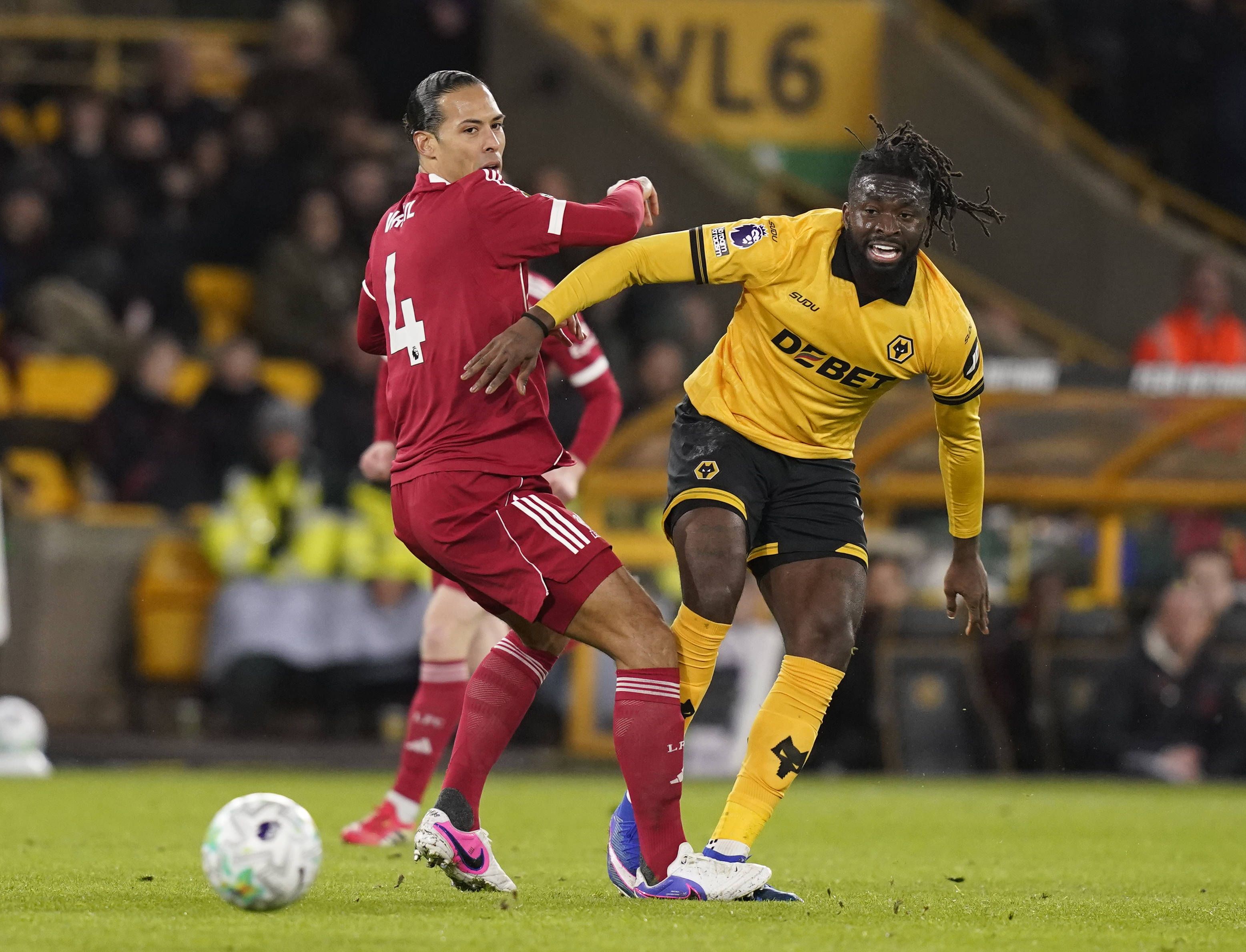 Virgil van Dijk of Liverpool turned by Tolu Arokodare of Wolverhampton Wanderers