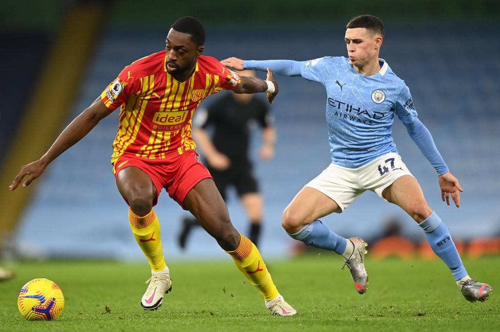 Semi Ajayi takes the ball from Manchester City's Phil Foden