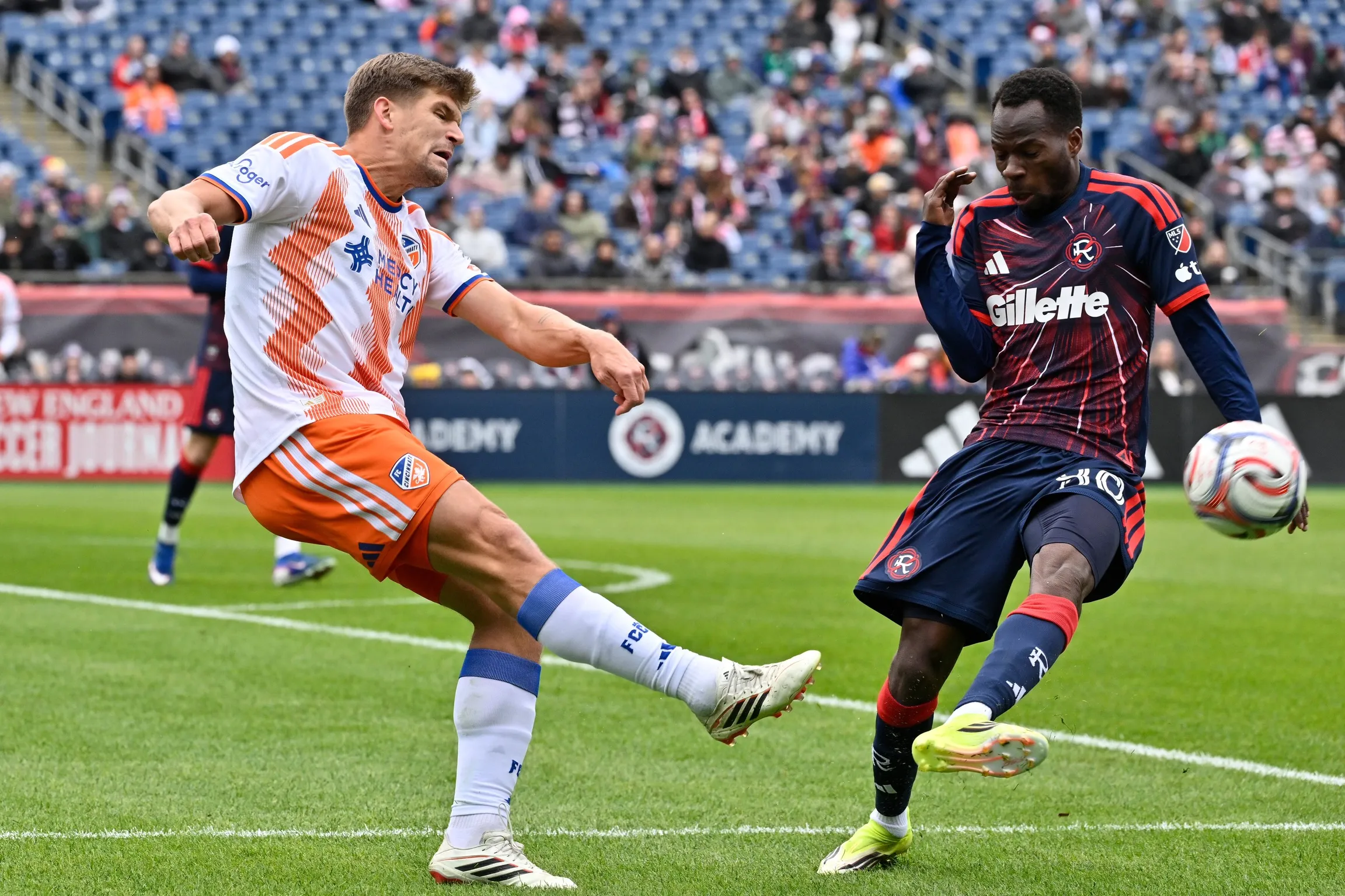 Cincinnati defender Nick Hagglund and New England Revolution midfielder Alhassan Yusuf