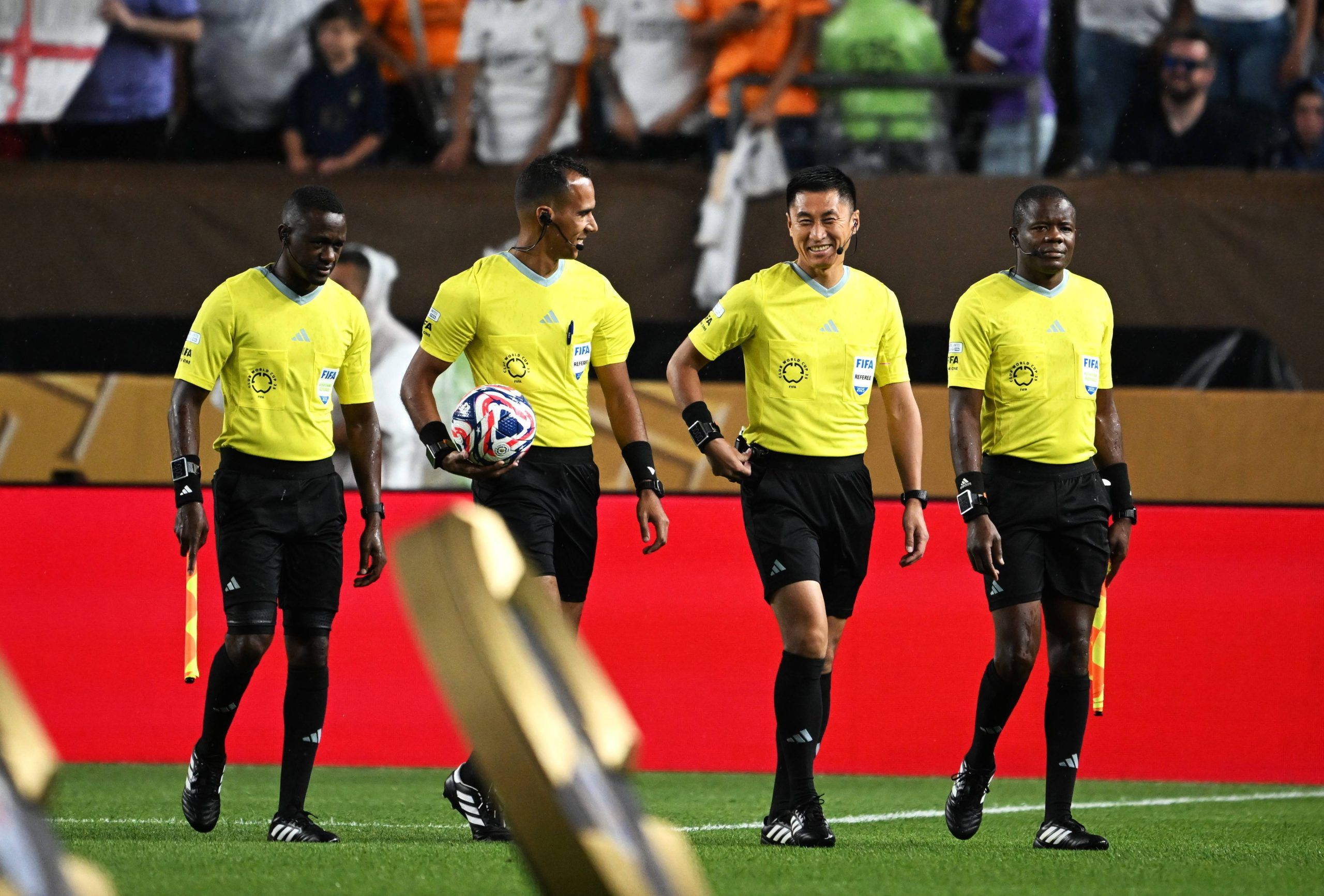 Referee Dahane Beida 2nd L and fourth official Ma Ning 2nd R enter the field before Real Madrid and Red Bull Salzburg at the FIFA Club World Cup 2025